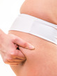 close up woman checking cellulite on her buttocks