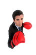 A businessman with boxing gloves on.