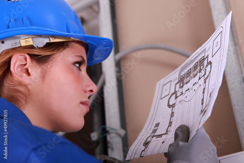Photo: Female electrician reading diagram Female electrician reading diagram