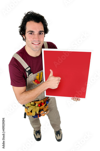 Photo: craftsman holding a red painted board craftsman holding a red painted board