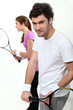 Couple playing tennis