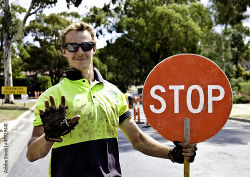 Photo: Roadworker controls traffic flow Roadworker controls traffic flow