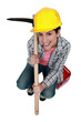 High-angle shot of a tradeswoman holding a pickaxe