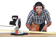 Man with band saw marking wood