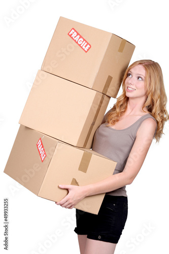 Photo: Woman carrying cartons Woman carrying cartons
