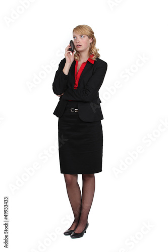 Photo: Exasperated woman talking on her mobile phone Exasperated woman talking on her mobile phone