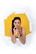 Woman busting through poster drinking orange juice