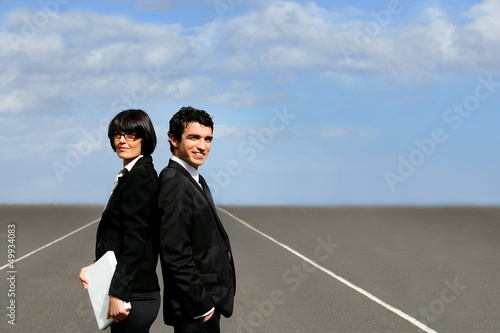 Photo: Business partners stood on runway Business partners stood on runway