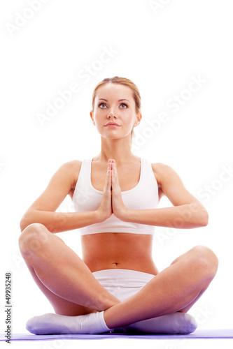 Photo: woman practicing yoga in lotus pose woman practicing yoga in lotus pose