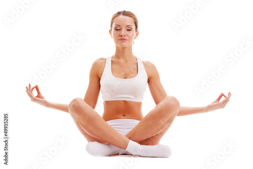 Photo: woman practicing yoga in lotus pose woman practicing yoga in lotus pose