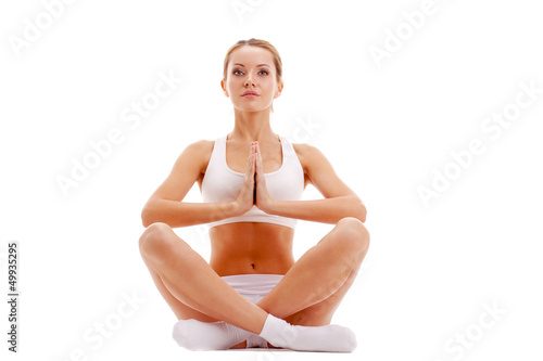 Photo: woman practicing yoga in lotus pose woman practicing yoga in lotus pose