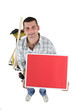 Handyman with a board left blank for your message