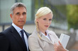 Business couple standing outside