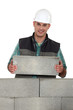 Tradesman placing a stone
