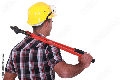 Photo: Tradesman carrying a pair of large clippers on his shoulder Tradesman carrying a pair of large clippers on his shoulder