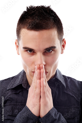 Photo: Businessman holding his hands in front of his mouth Businessman holding his hands in front of his mouth