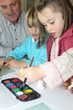 Senior man watching grandchildren paint