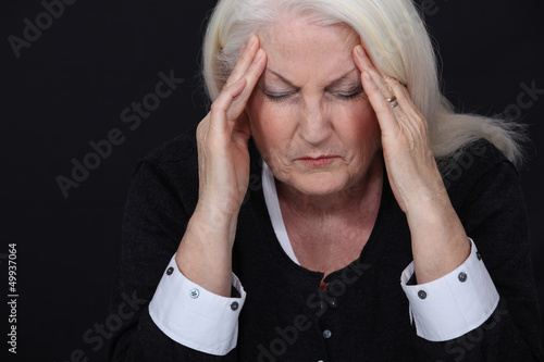 Photo: Elderly woman suffering from a headache Elderly woman suffering from a headache