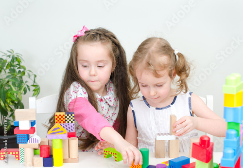 Photo: Two little girl playing with building blocks Two little girl playing with building blocks