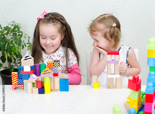 Photo: Two little girl playing with building blocks Two little girl playing with building blocks