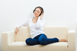 woman on the sofa listening to music