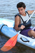 Photo: young boy on boat paddling young boy on boat paddling
