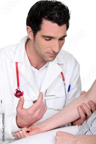 Photo: Doctor giving patient injection Doctor giving patient injection
