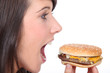 Brunette girl eating hamburger, profile-view