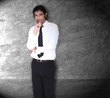 Man in front of gray wall