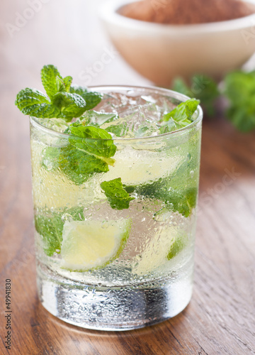 Photo: Mojito served in a glass with crushed ice and lime Mojito served in a glass with crushed ice and lime