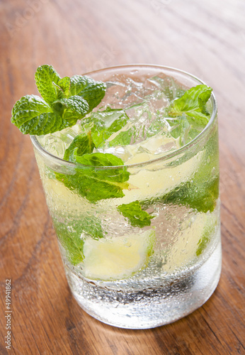 Photo: Mojito served in a glass with crushed ice and lime Mojito served in a glass with crushed ice and lime