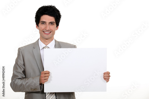 Photo: Businessman with a blank board Businessman with a blank board