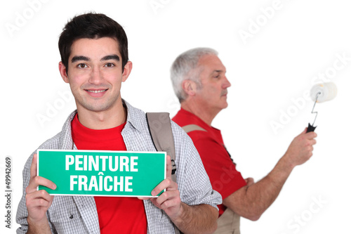 Photo: A painter and his apprentice. A painter and his apprentice.