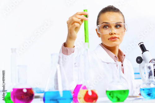 Photo: Young female scientist working in laboratory Young female scientist working in laboratory