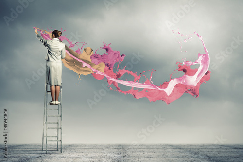 Photo: Young woman drawing splashes Young woman drawing splashes