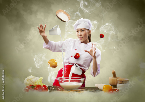 Photo: Asian female cooking with magic Asian female cooking with magic