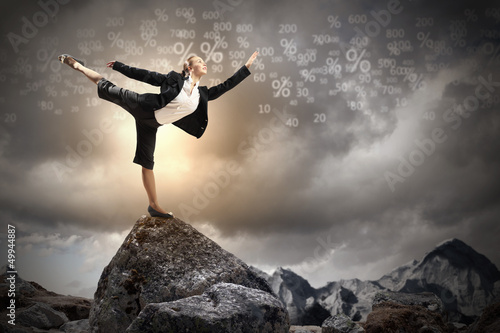 Photo: businesswoman standing atop of mountain businesswoman standing atop of mountain