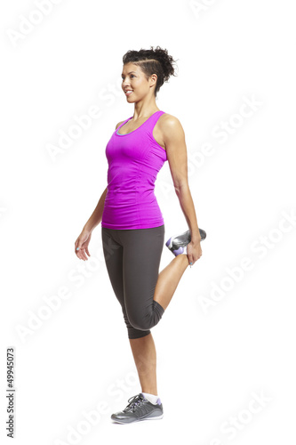 Photo: Muscular young woman stretching in sports outfit Muscular young woman stretching in sports outfit