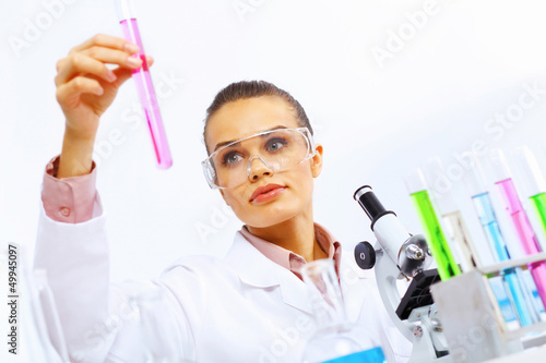 Photo: Young female scientist working in laboratory Young female scientist working in laboratory