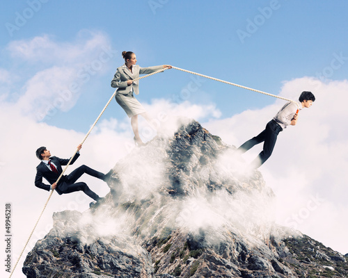 Photo: Three business people pulling rope Three business people pulling rope