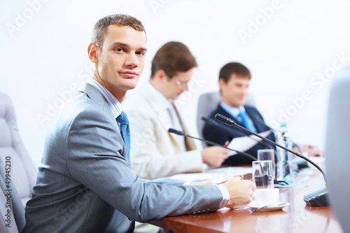 Photo: Three businesspeople at meeting Three businesspeople at meeting