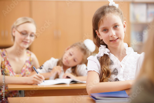 Photo: Little girl at school class Little girl at school class