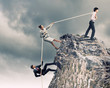 Three business people pulling rope