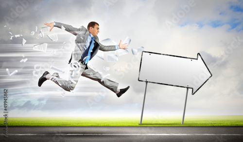 Photo: Businessman running on the road Businessman running on the road