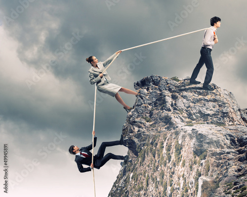 Photo: Three business people pulling rope Three business people pulling rope