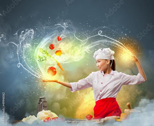 Photo: Asian female cooking with magic Asian female cooking with magic