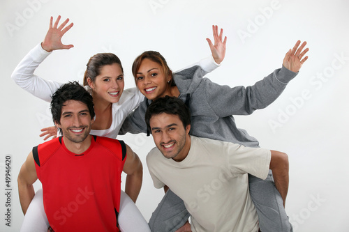 Photo: two young men carrying women on their backs two young men carrying women on their backs