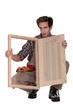 Carpenter displaying a wooden shutter