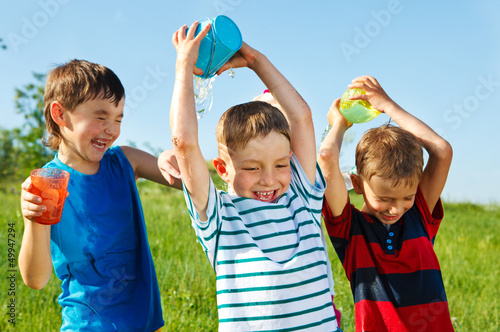 Photo: Happy boys splashing water Happy boys splashing water