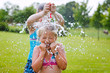 girls having fun outdoor with water balloons